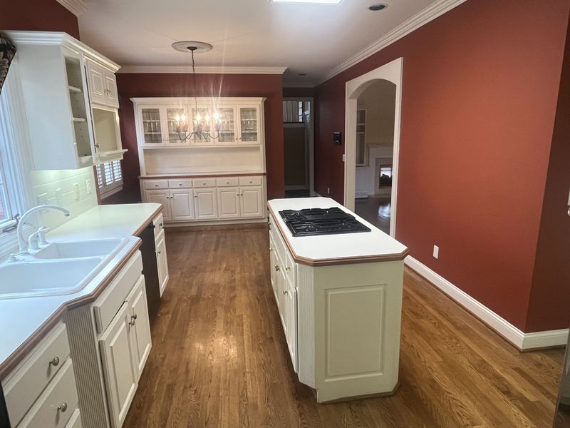 Abbottsford kitchen before renovation — dated red walls and white cabinets